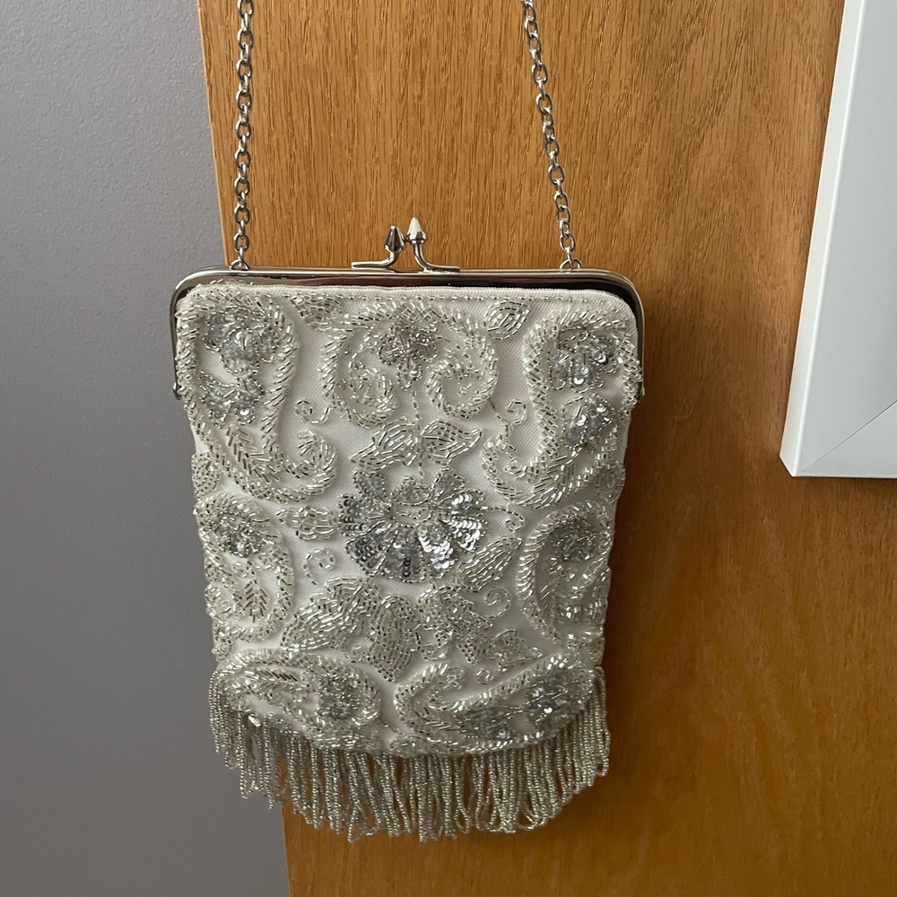 Brand new never used. Bought for wedding and decided did not need a purse.